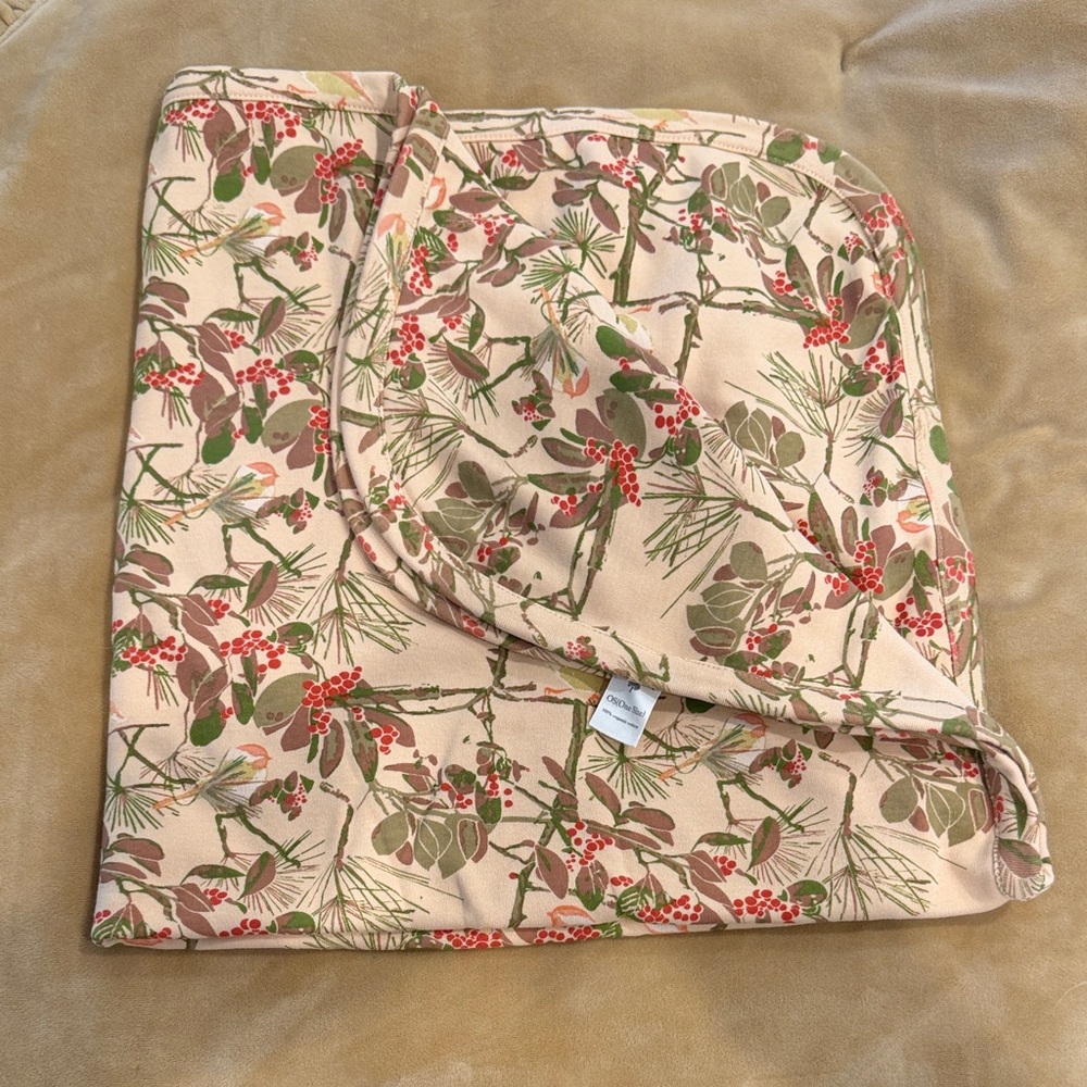 kate quinn swaddle blanket - cream background with green and red botanical print